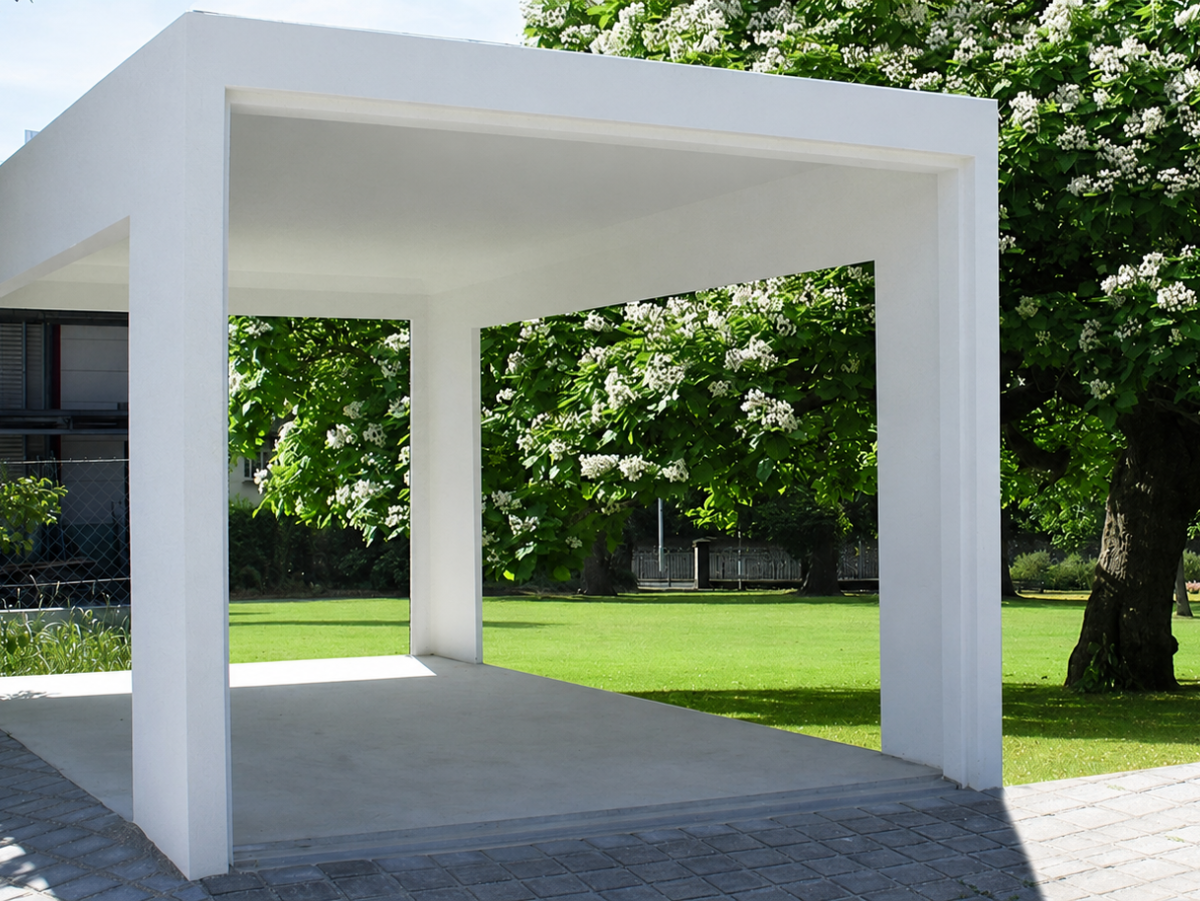 Weißes Carport vor gepflegtem Garten mit blühenden Bäumen und Haus im Hintergrund.